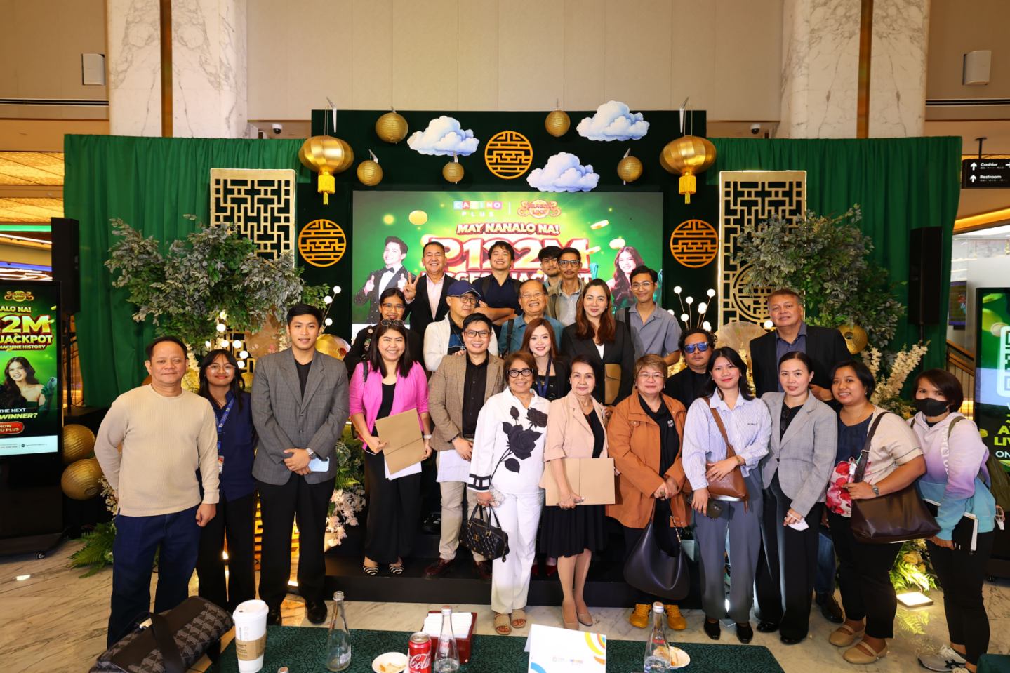 Corporate Communications Director Joanna Christina Tinio (center right) and Assistant Corporate Communicatons Manager Job Manahan (center left) pose with members of the media during the ceremonial jackpot turnover on Sept. 9, 2026.